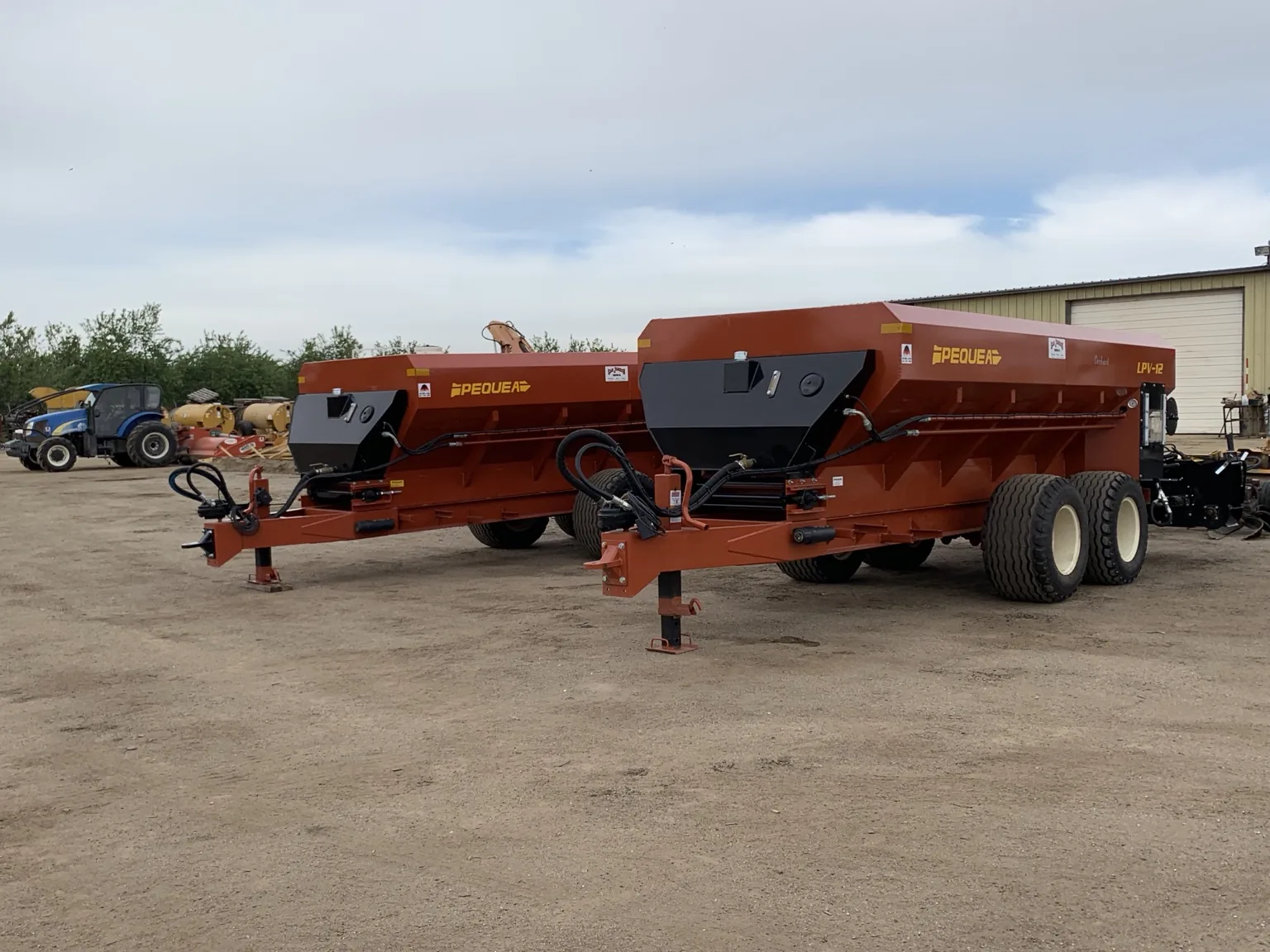 Two Pequea material spreaders